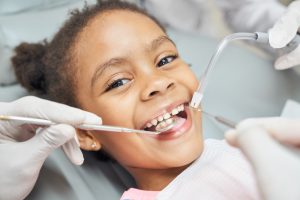 dentist examining child's smile